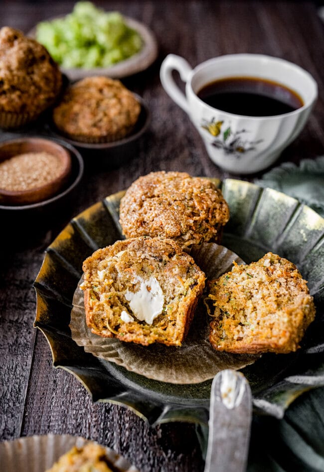 zucchini carrot muffin cut in half with butter.