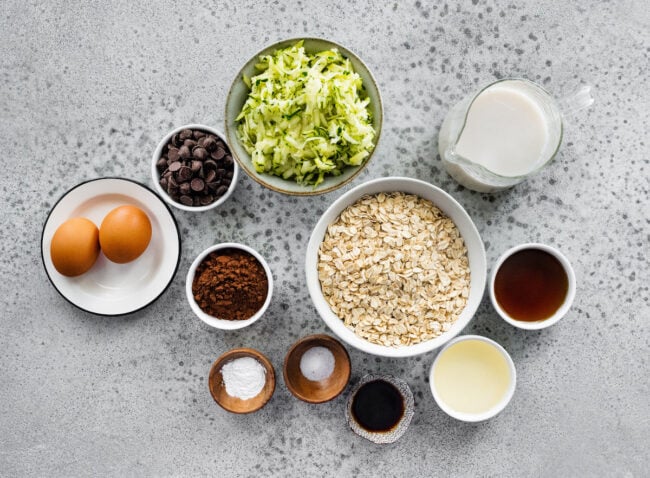 ingredients in bowls for chocolate zucchini baked oatmeal.