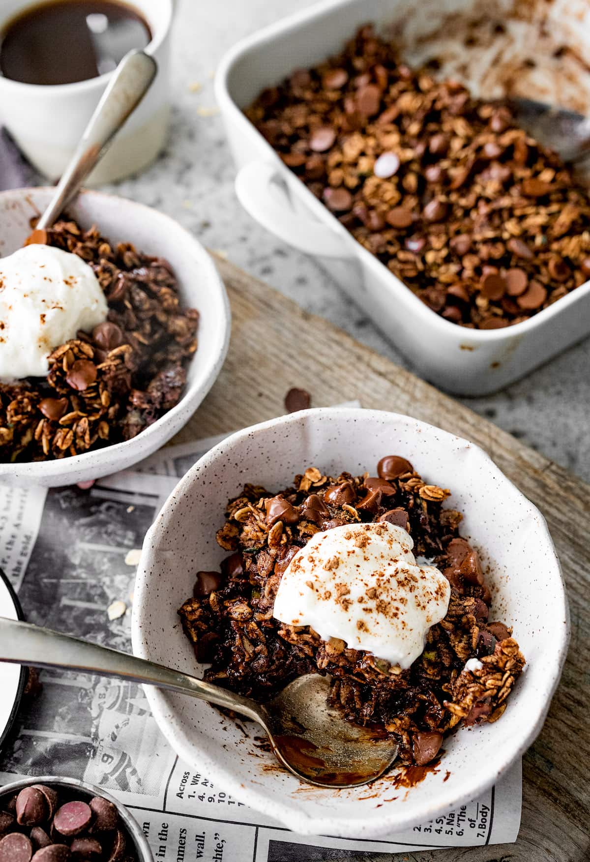 chocolate zucchini baked oatmeal in bowls with whipped cream. 