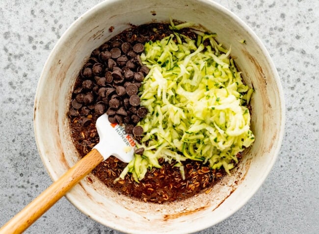 chocolate zucchini baked oatmeal in bowl with spatula. 