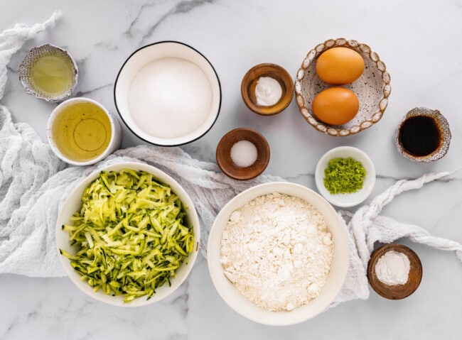 lime zucchini loaf ingredients in bowls.