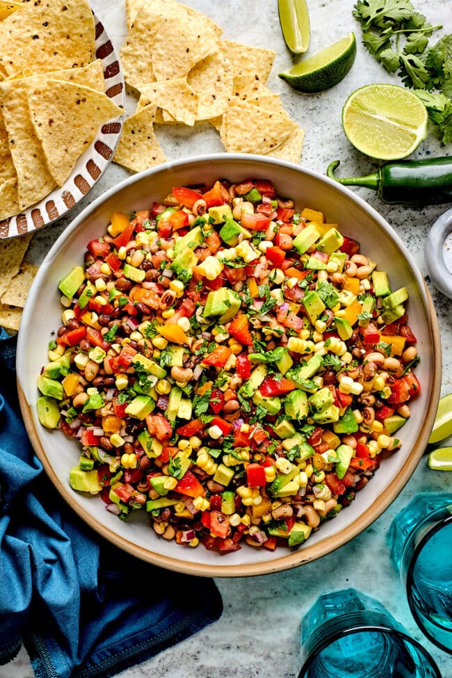 cowboy caviar in bowl with tortilla chips.