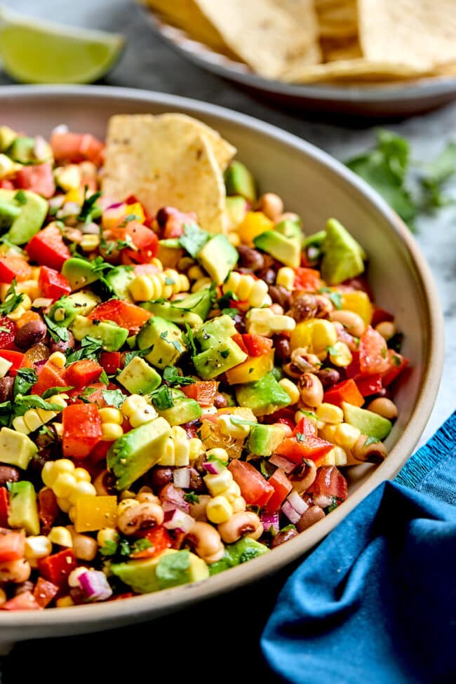 cowboy caviar with tortilla chip in bowl.