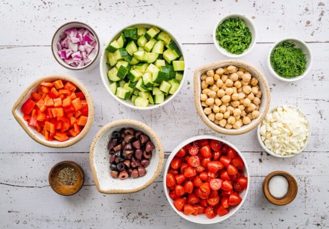 Greek chickpea salad ingredients in bowls.