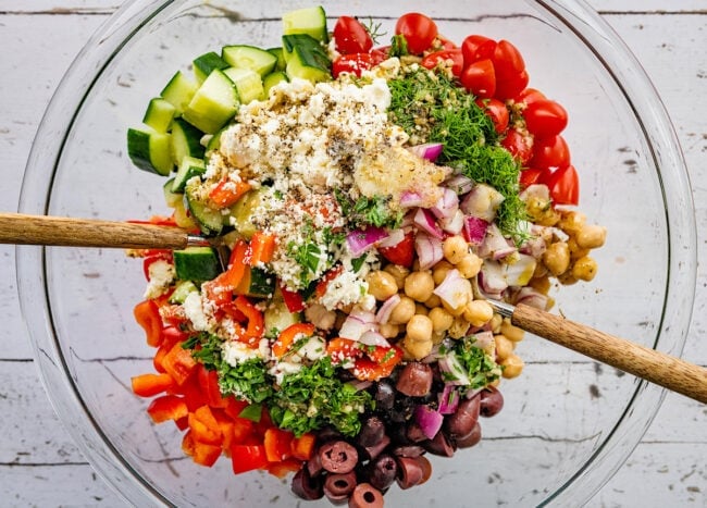 Greek chickpea salad ingredients in bowl.