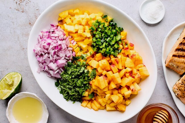 mango peach salsa ingredients in bowl.