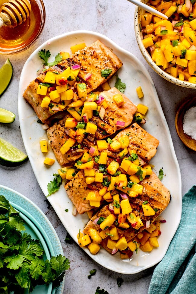 grilled salmon with mango peach salsa on platter. 