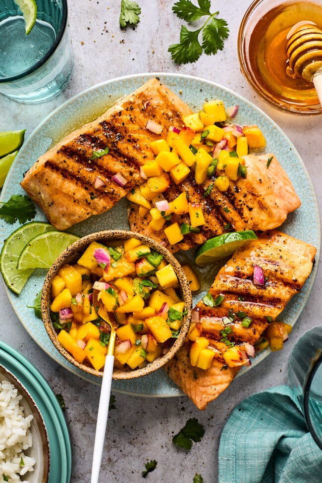 grilled salmon on plate with mango peach salsa. 