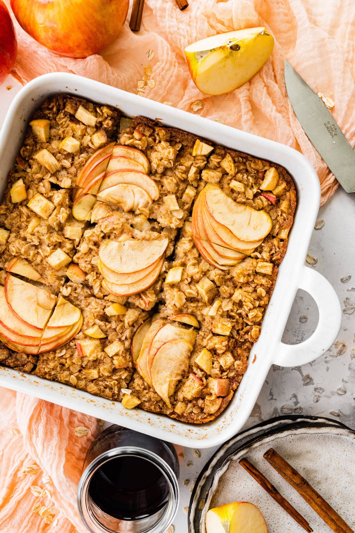 apple cinnamon baked oatmeal cut in squares in pan. 