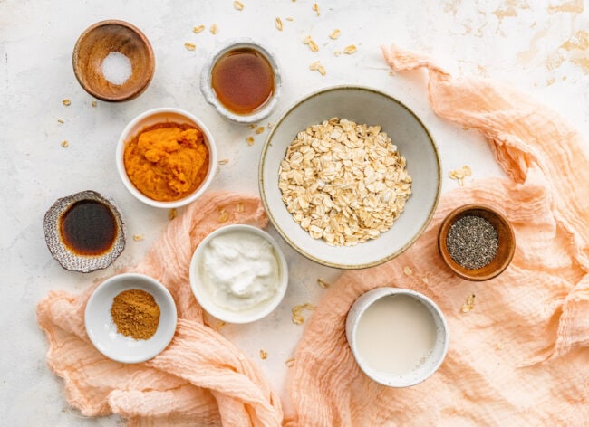 pumpkin overnight oats ingredients in bowls.