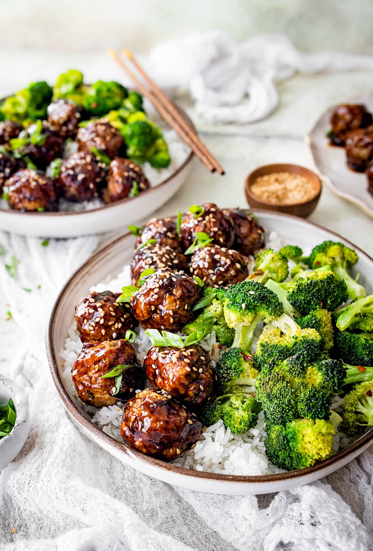 Teriyaki chicken meatballs in bowl with rice and broccoli. 