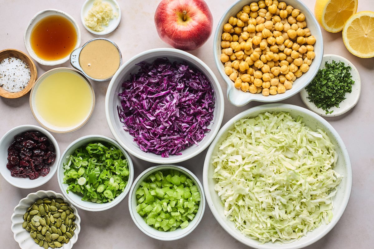 ingredients to make apple slaw in bowls. 