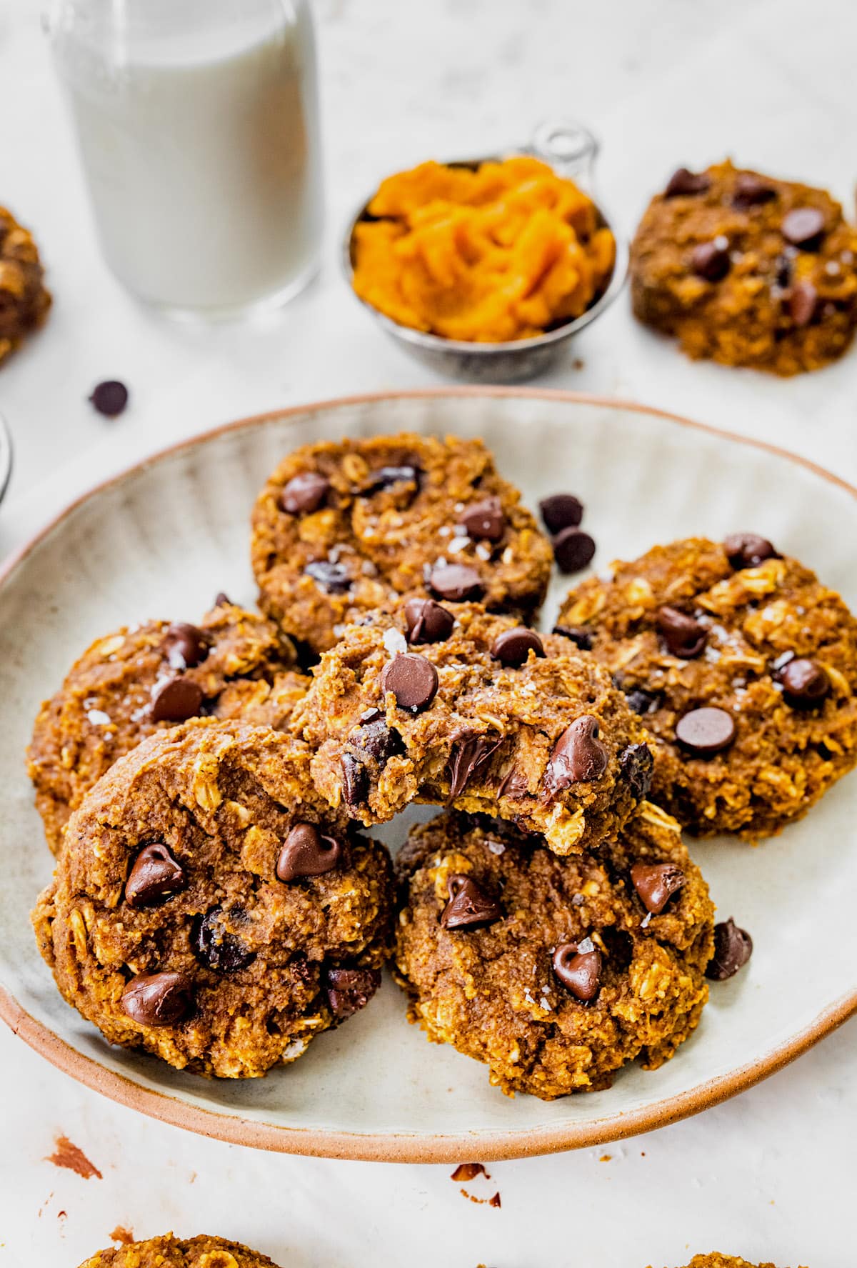 pumpkin breakfast cookies with chocolate chips on plate.