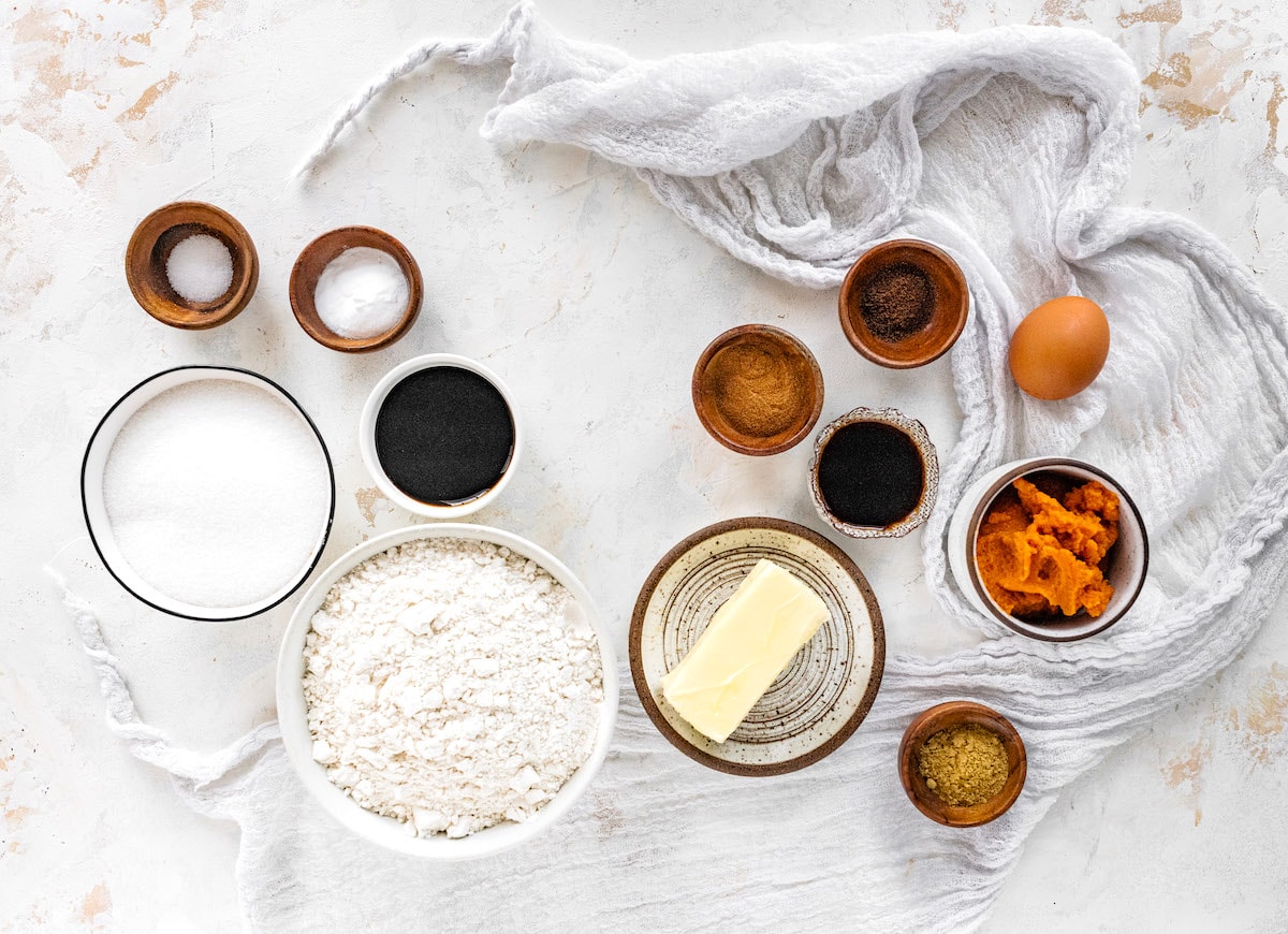 pumpkin gingersnap cookie ingredients in bowl with kitchen towel. 