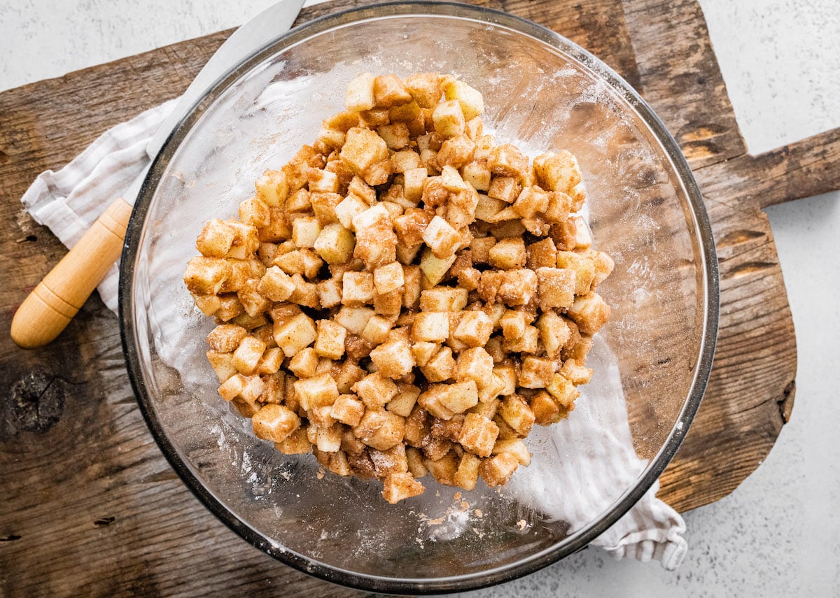 apple filling in large bowl for salted caramel apple crumb bars. 