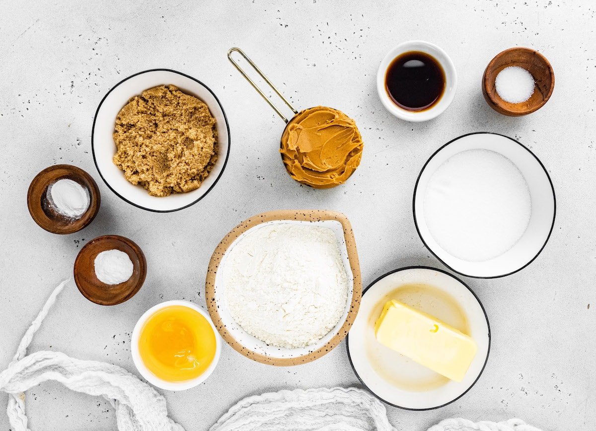 peanut butter cookie ingredients measured out in bowls. 