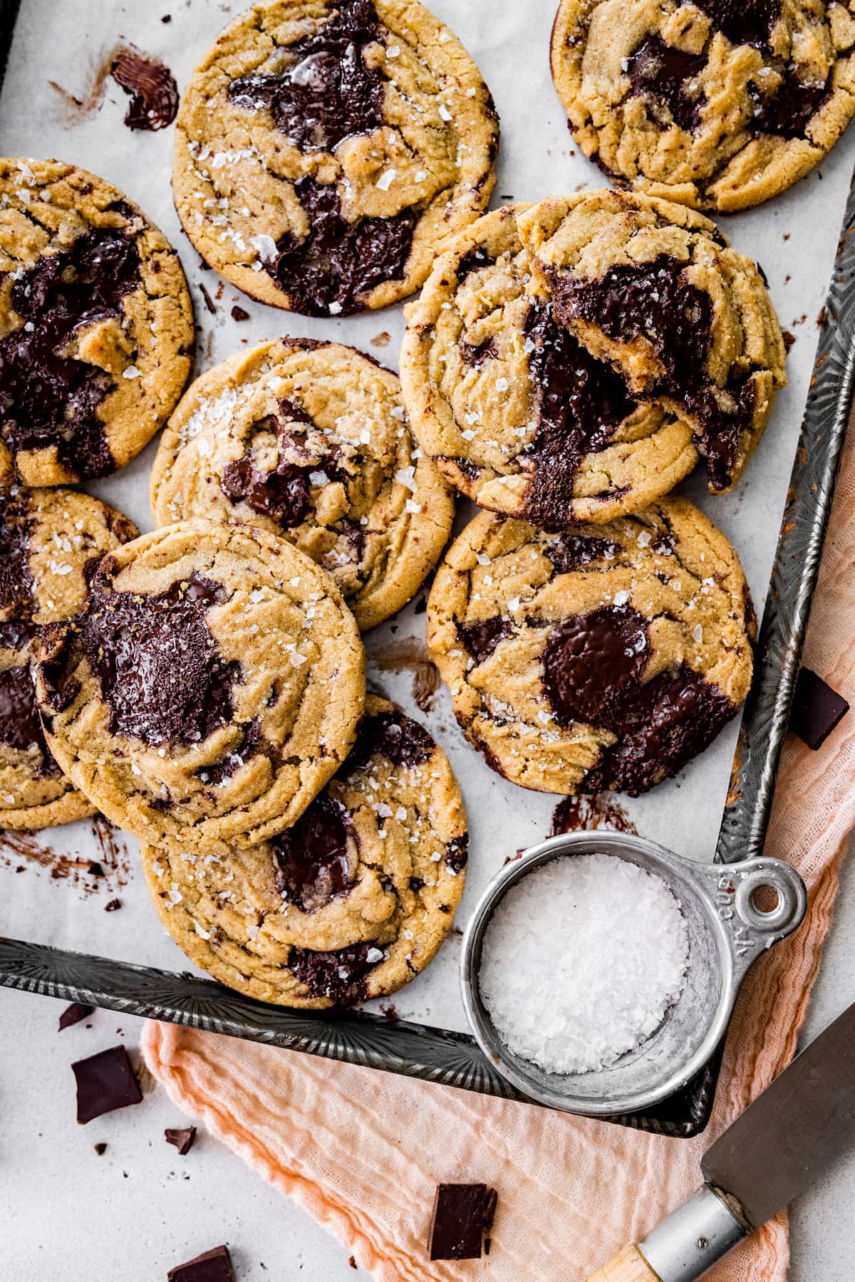 brown butter chocolate chip cookies on baking sheet with parchment paper.