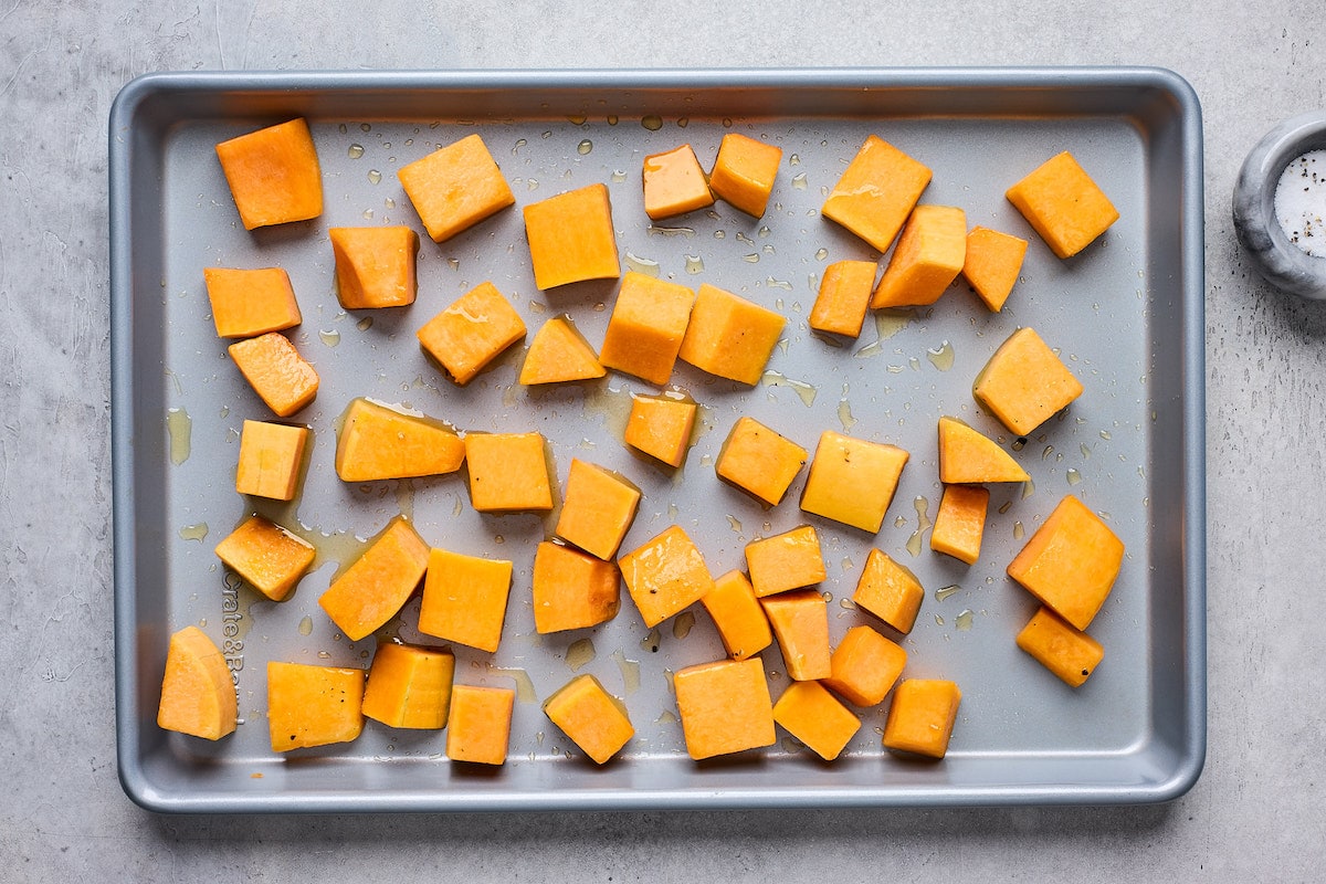 butternut squash on baking sheet drizzled with olive oil. 