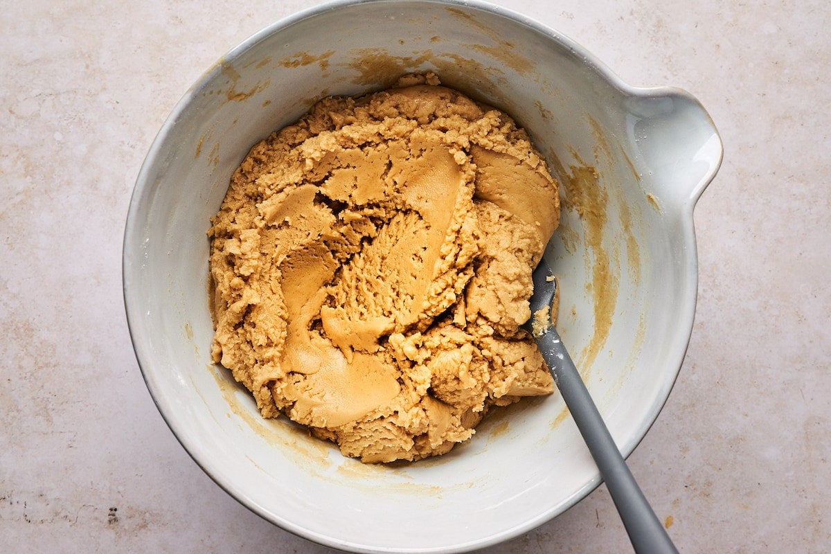 peanut butter fudge mixture in bowl with spatula. 