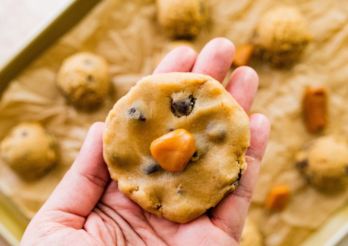 chocolate chip cookie dough flattened out with a caramel in the center. 