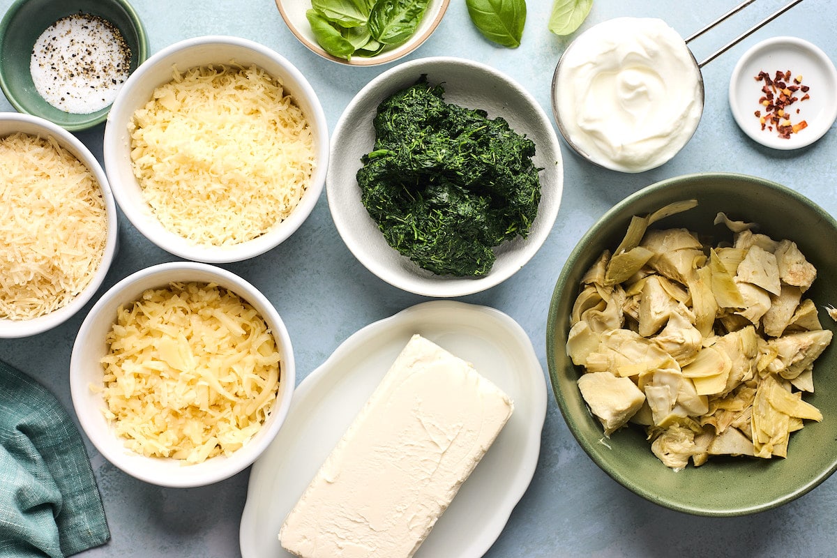 spinach artichoke ingredients in bowls.