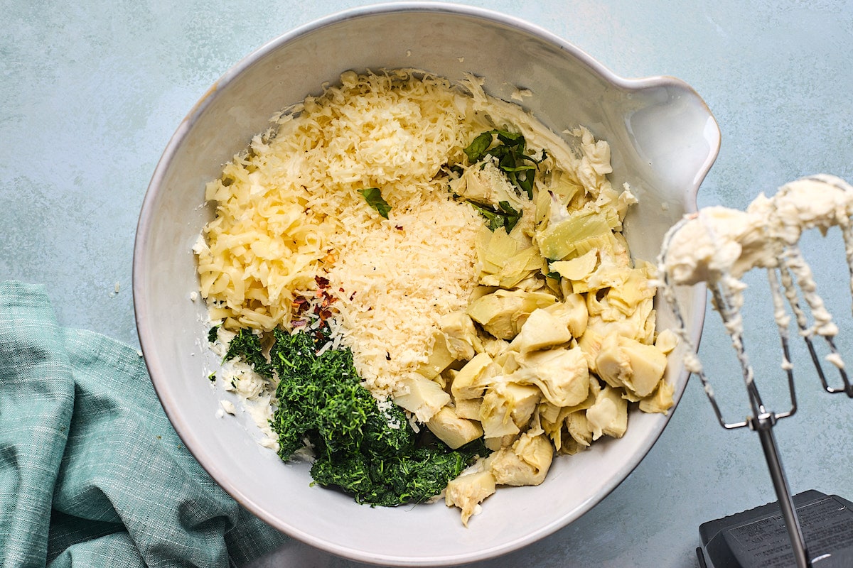 spinach artichoke dip ingredients in mixing bowl.