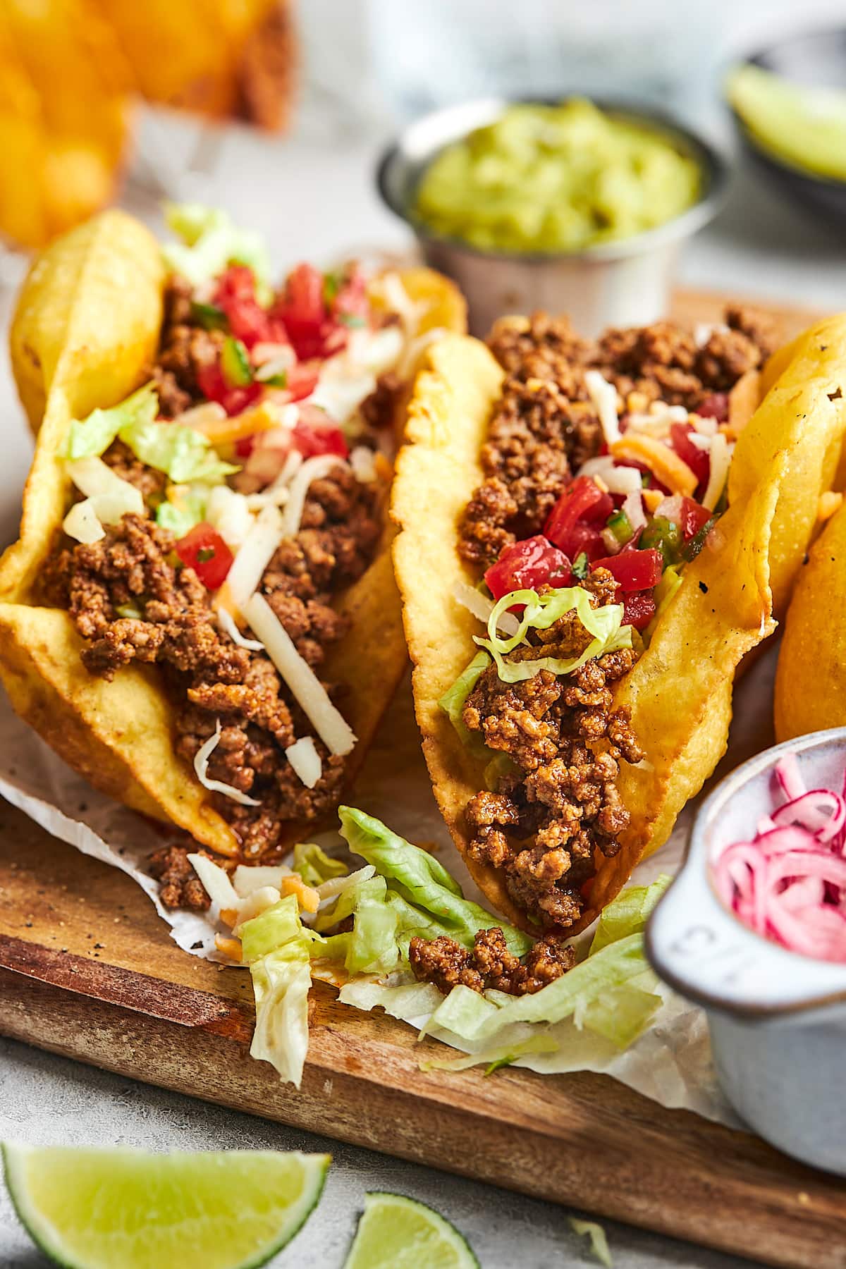 ground beef tacos in crispy taco shells with lettuce, tomato, and cheese. 