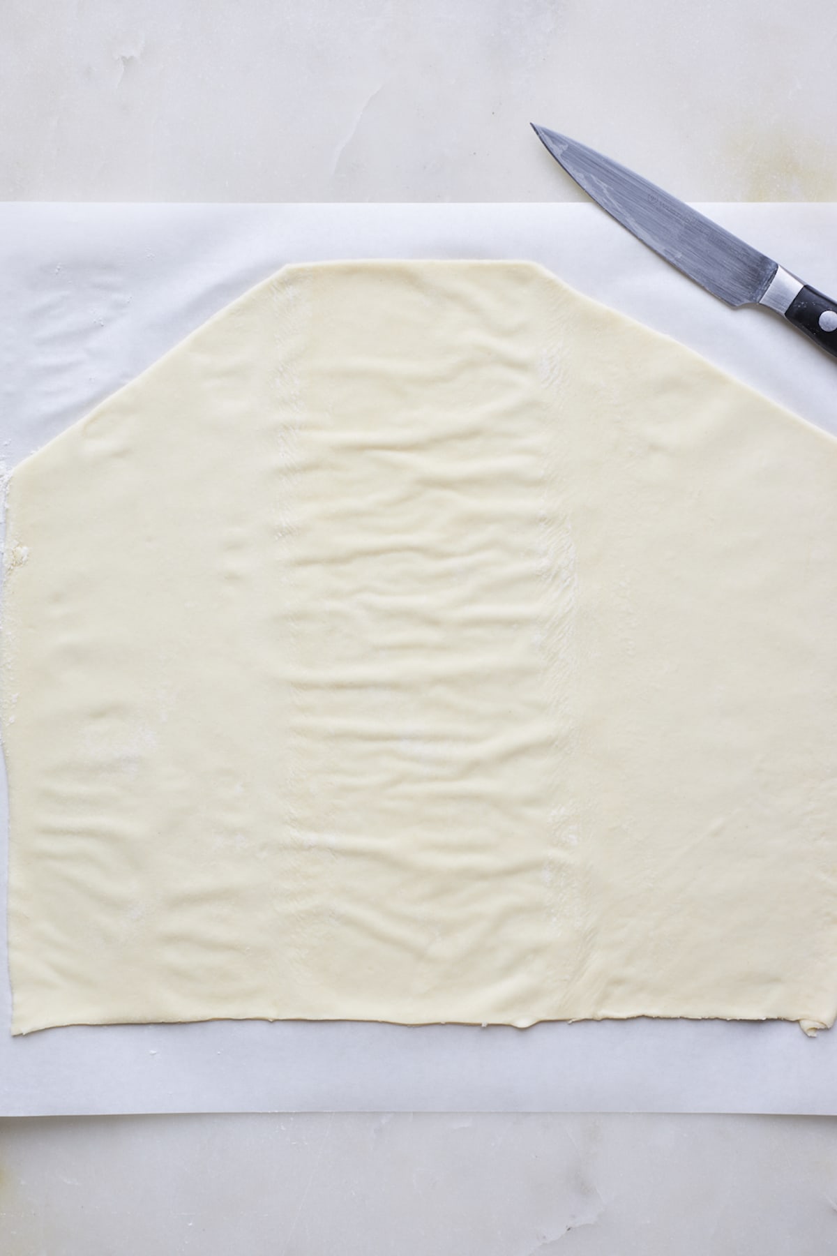 puff pastry sheet rolled out and cut with a knife to make a breakfast bread. 