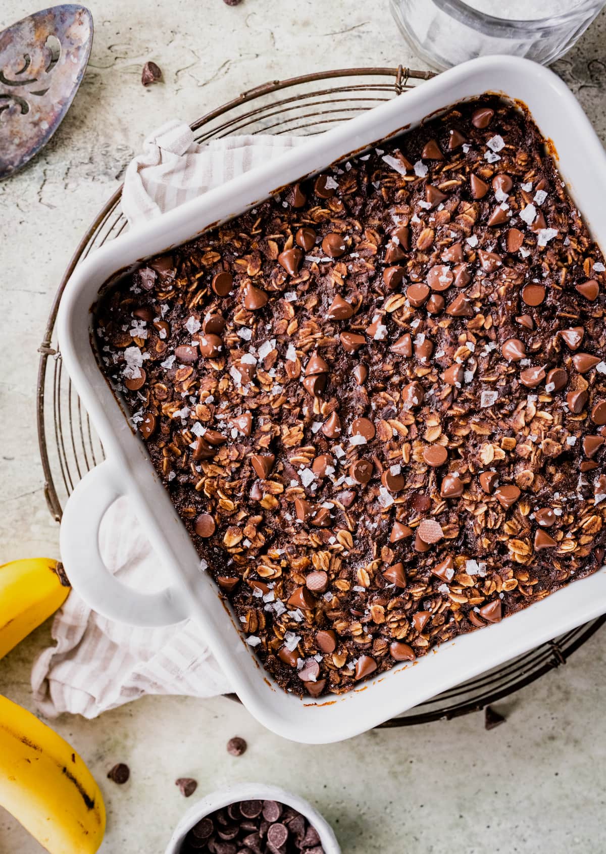 chocolate banana baked oatmeal in baking dish on cooling rack.