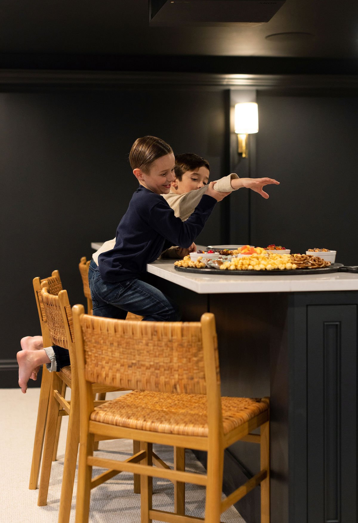 kids eating snacks in basement theatre room. 