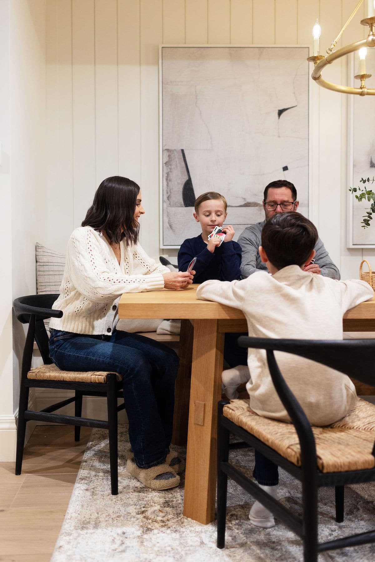 family playing Uno at dining table. 