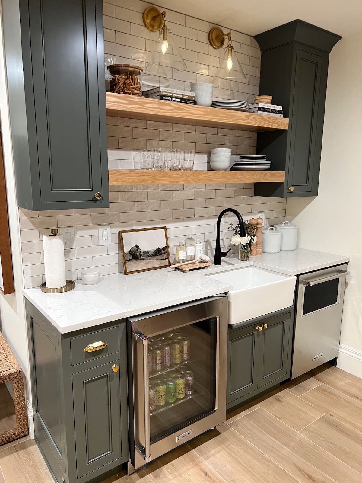 basement kitchen with green cabinets and open shelves. 