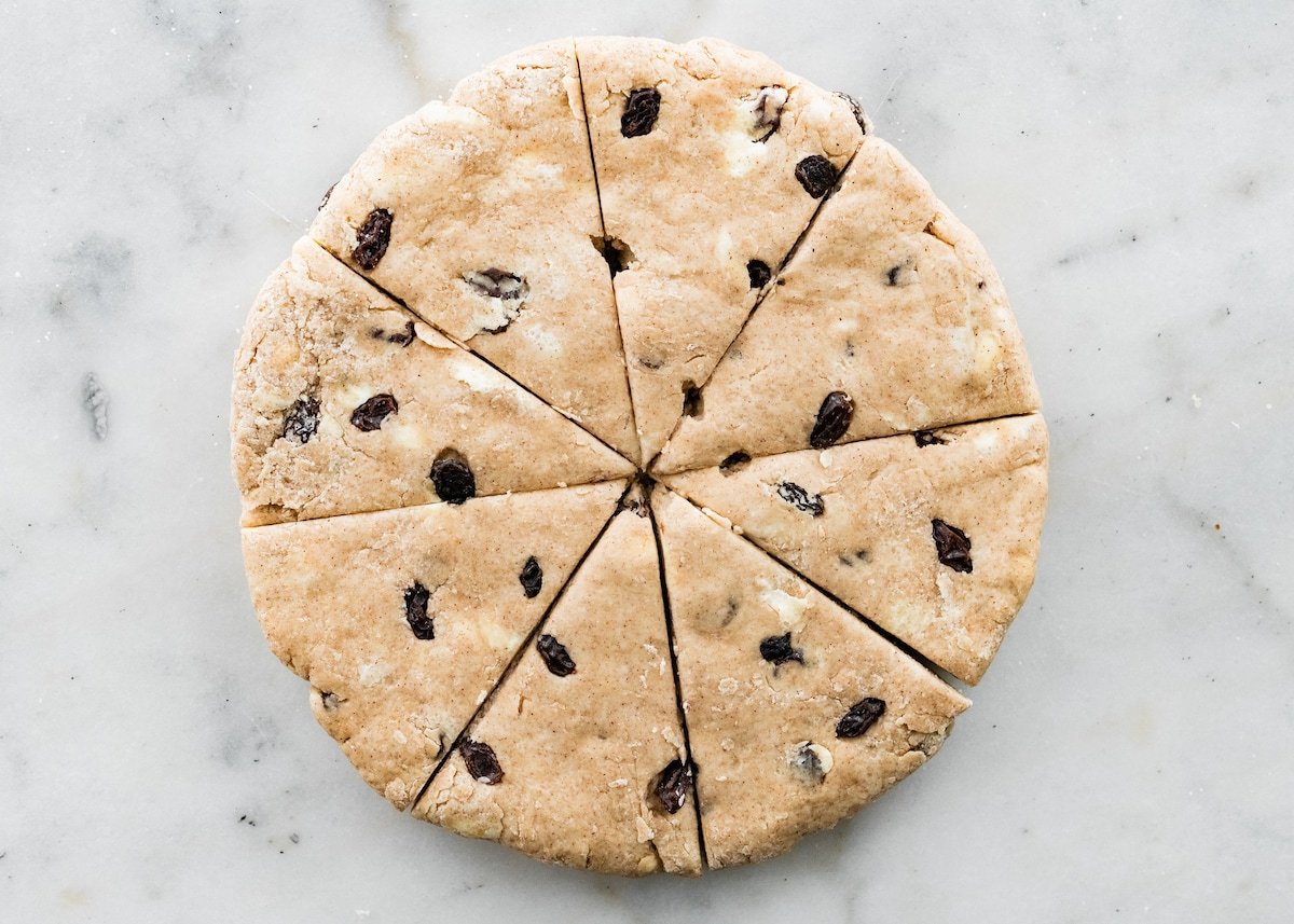 cinnamon raisin scone dough rolled into a circle and cut into 8 triangles. 