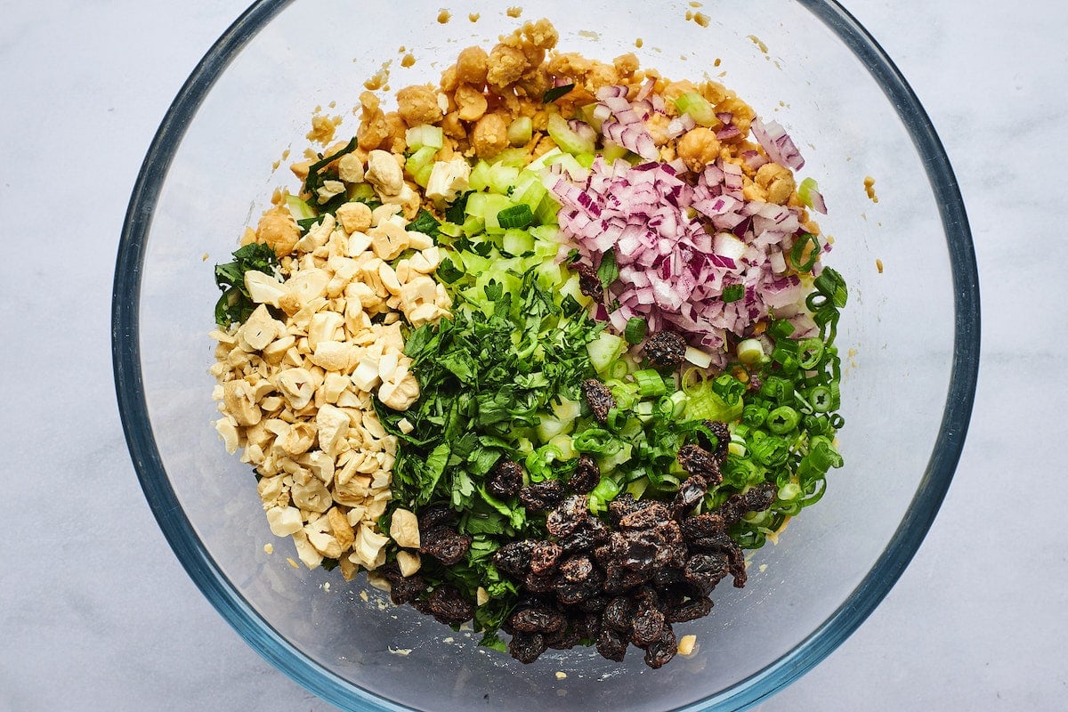 curried chickpea salad ingredients in large bowl.