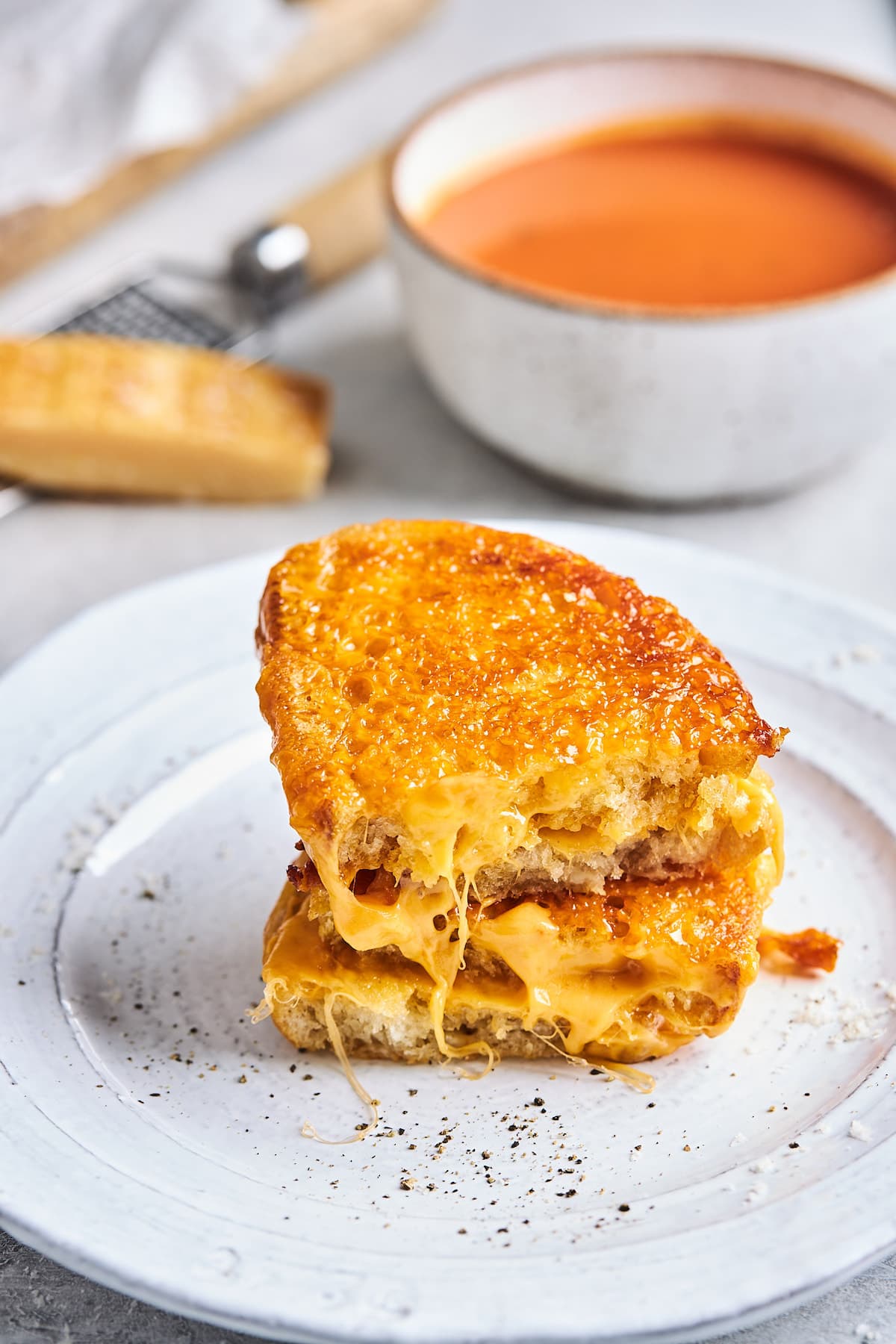 grilled cheese cut in half and stacked on plate. 