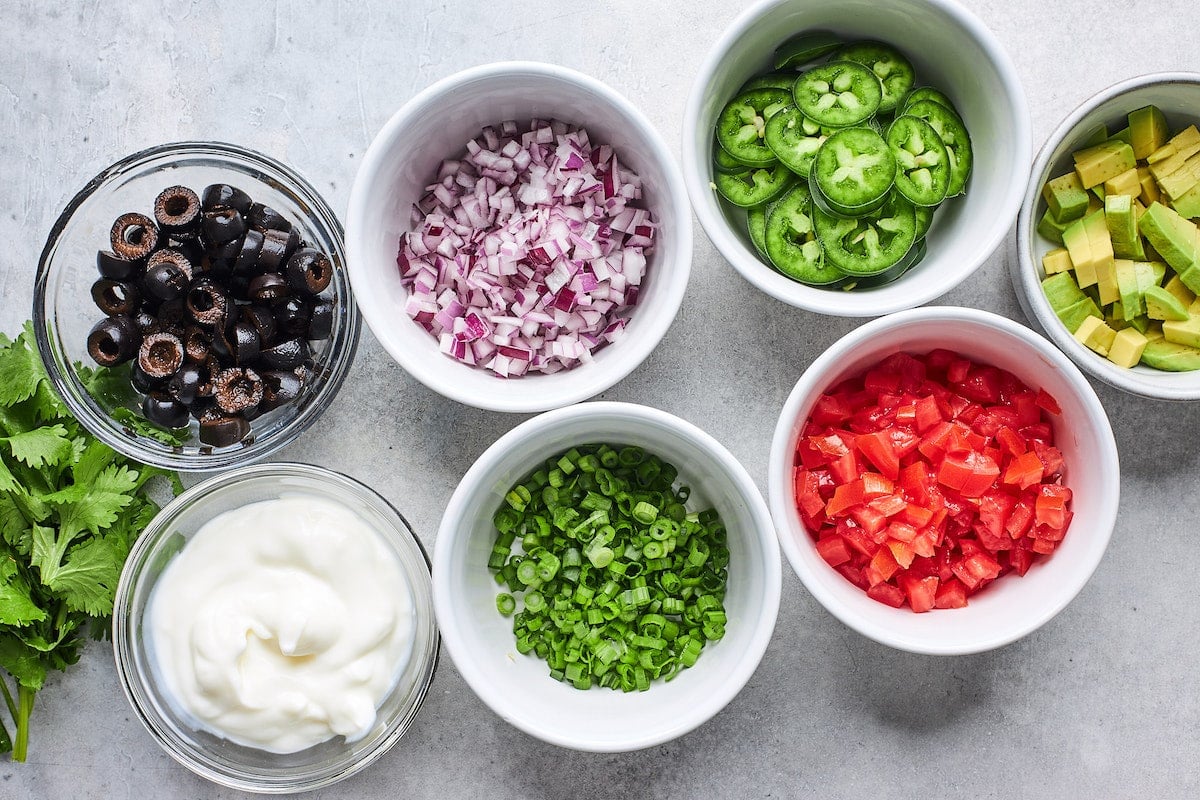 toppings in bowls for nachos. 