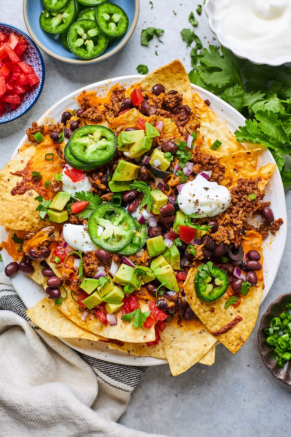 plate of nachos with toppings. 