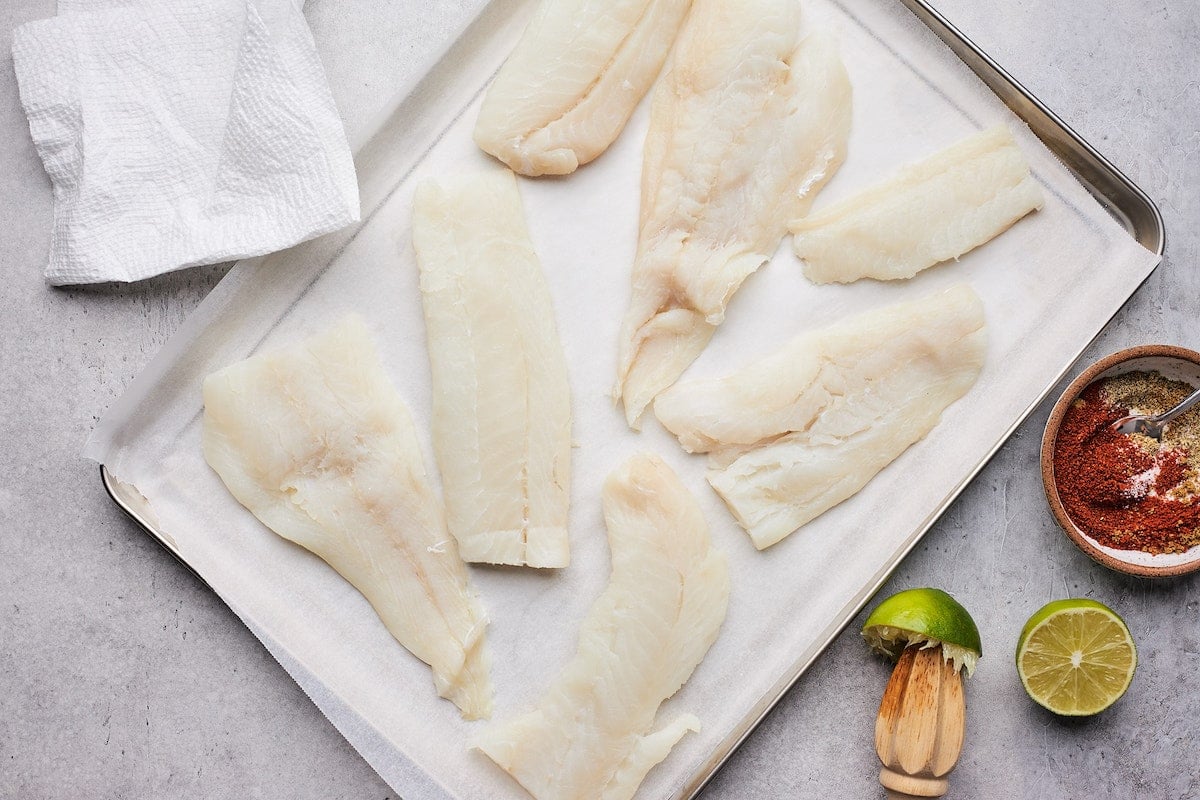 cod on sheet pan with parchment paper with lime juice. 
