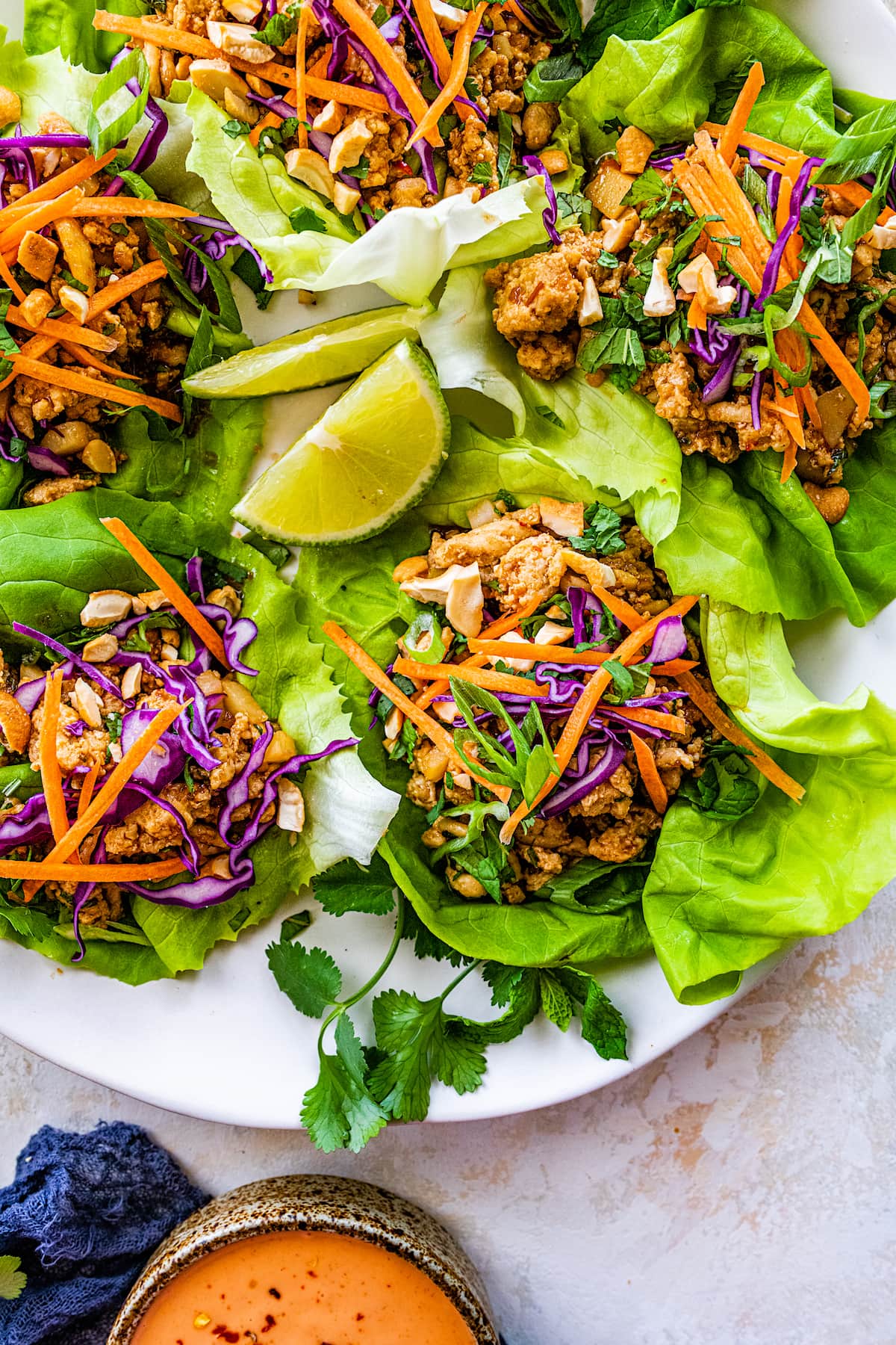 chicken lettuce wraps on white serving platter. 