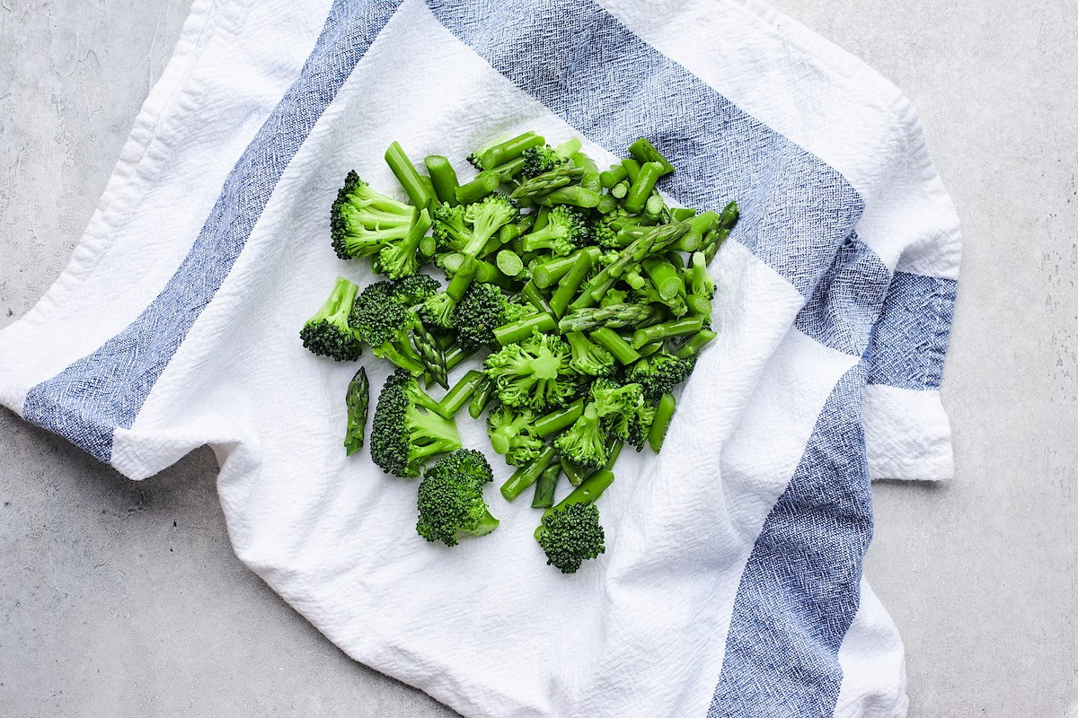 blanched broccoli and asparagus drying on tea towel. 