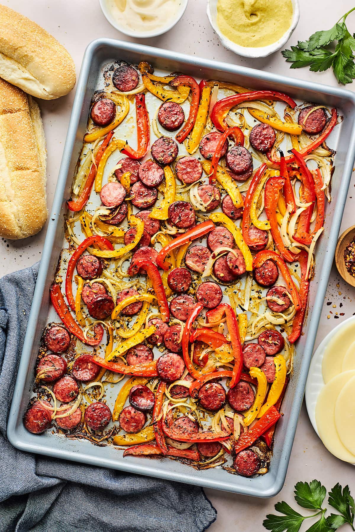 cooked sausage, peppers, and onion on large sheet pan.