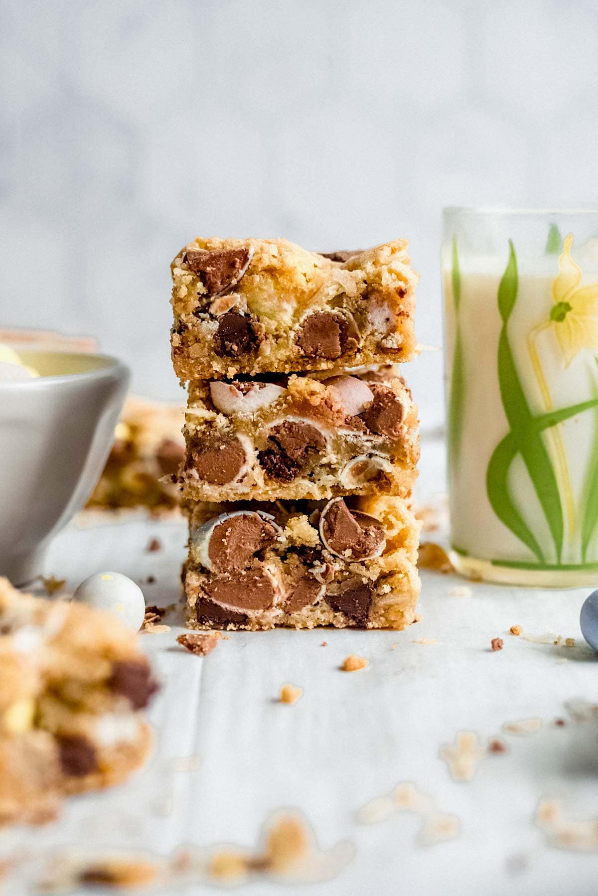 stack of Cadbury blondies with glass of milk. 