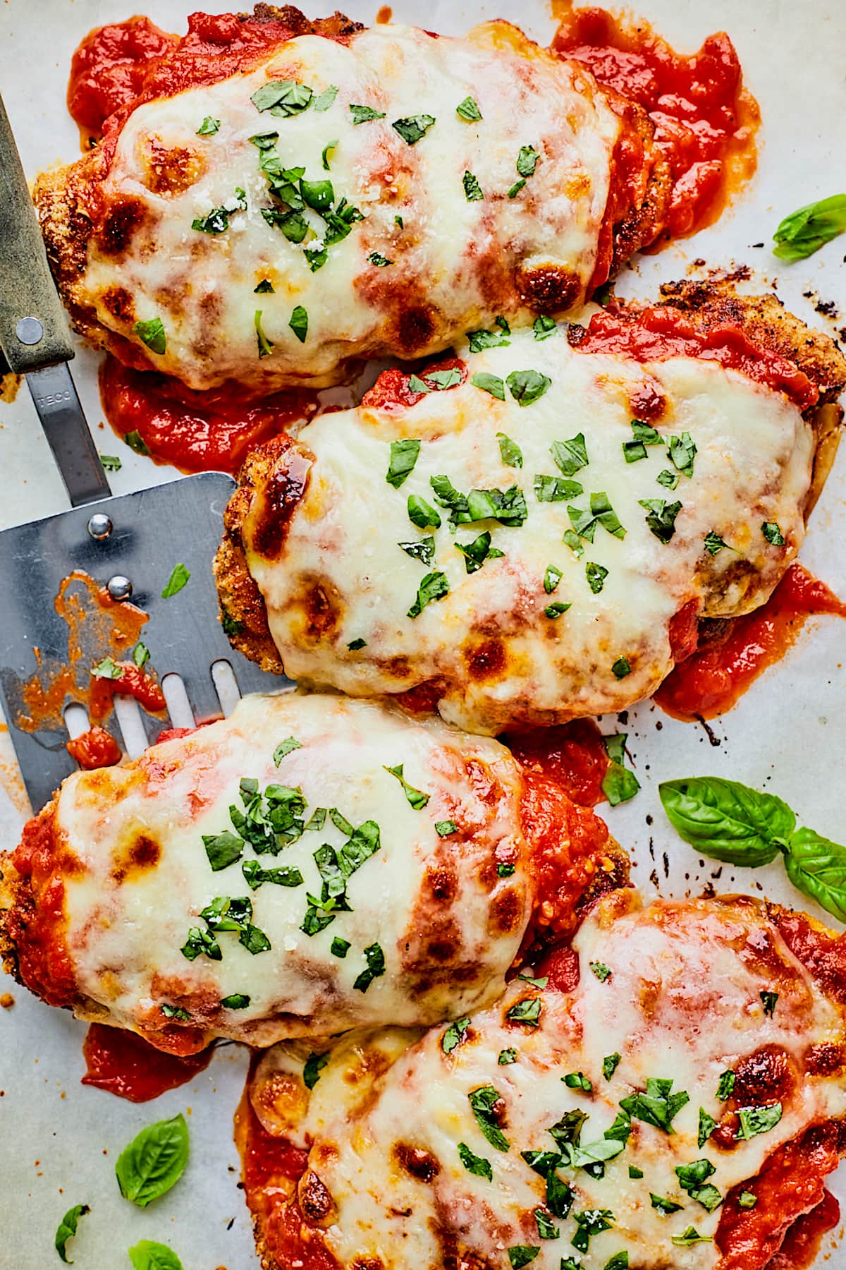 chicken parmesan with marinara sauce with melted mozzarella cheese and basil.