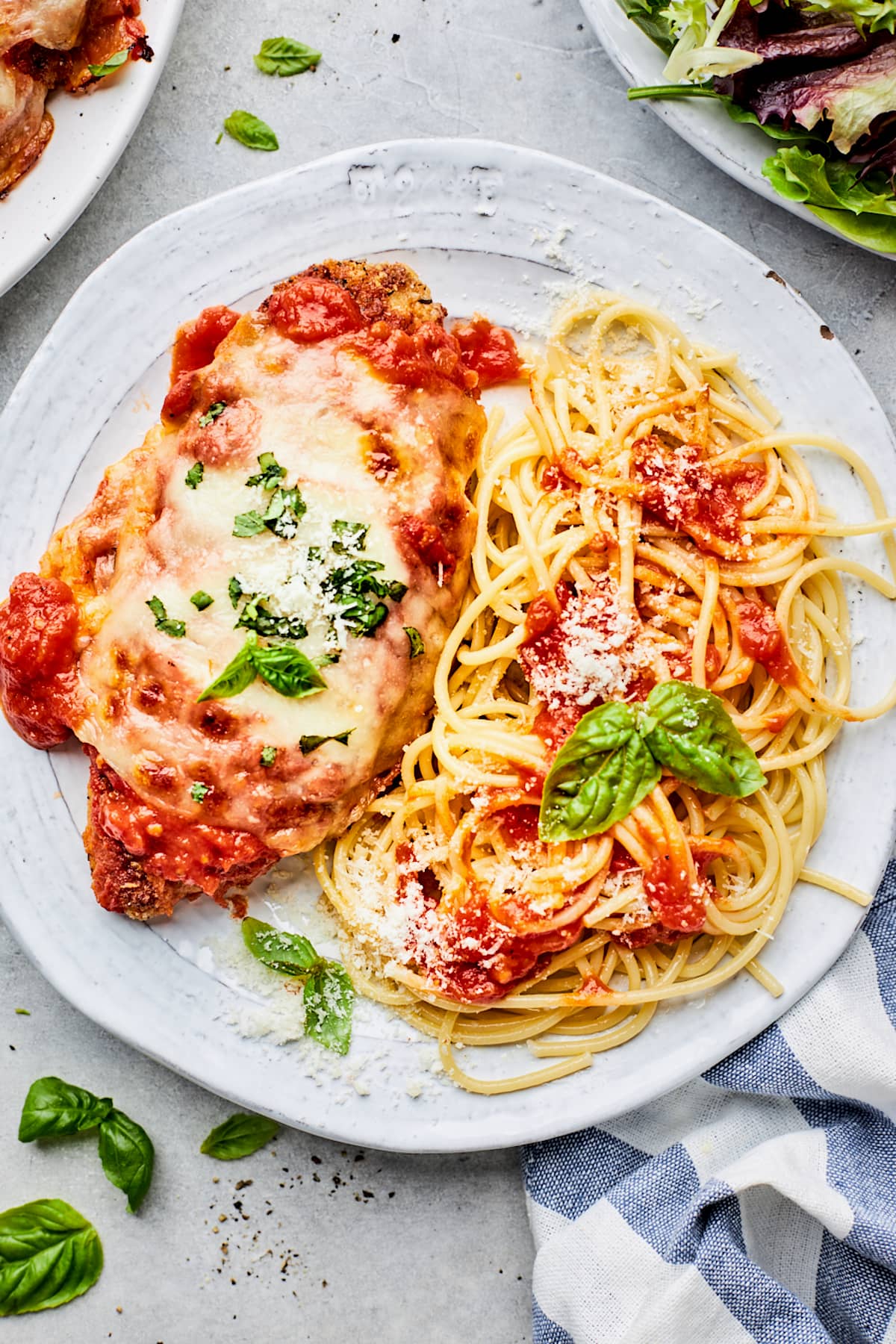 chicken parmesan on plate with spaghetti. 