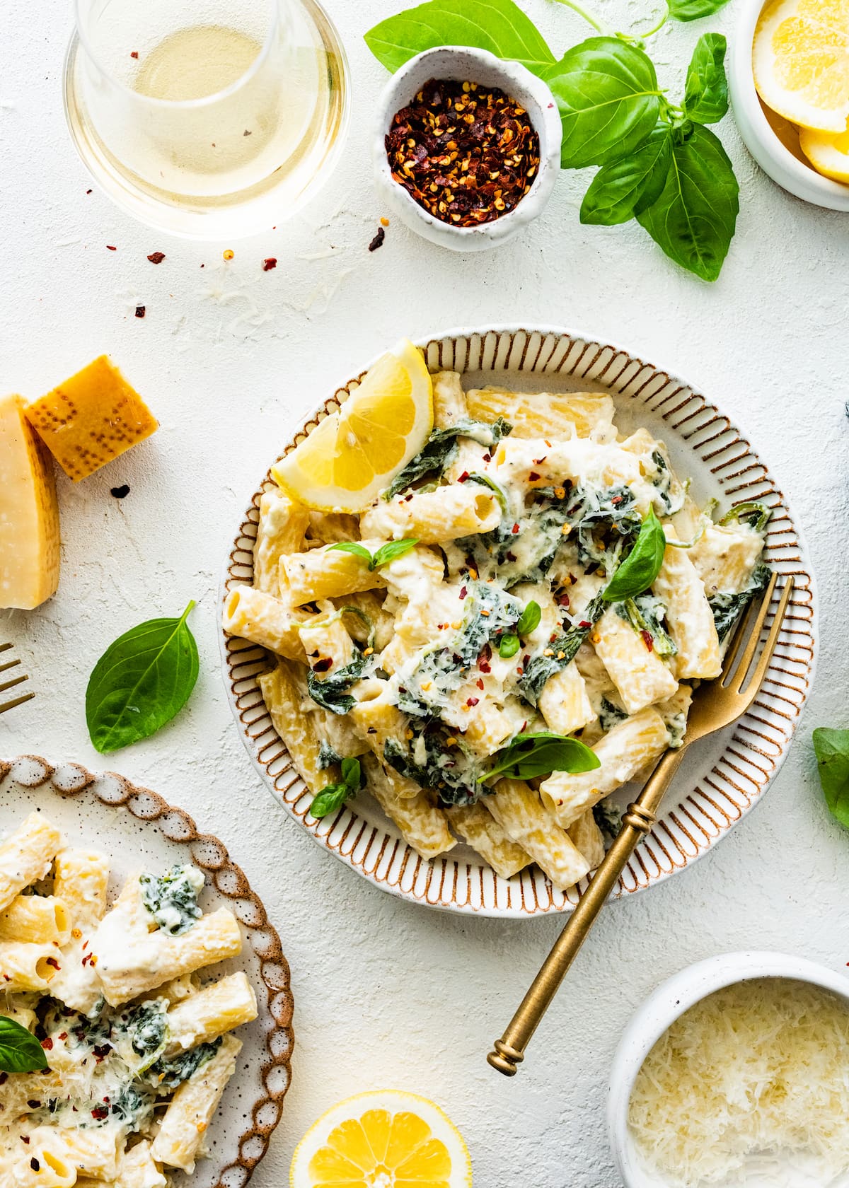 lemon ricotta pasta in bowl with gold fork. 