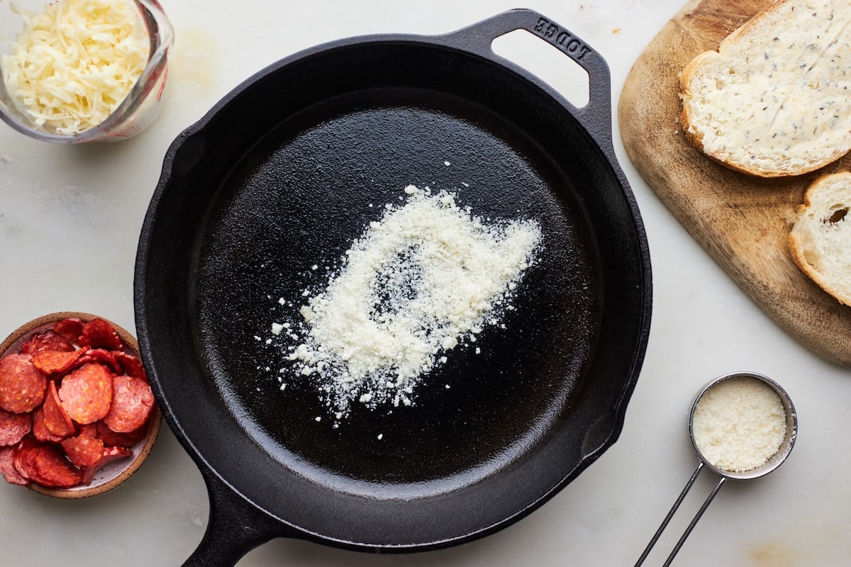 Parmesan cheese in cast iron skillet. 