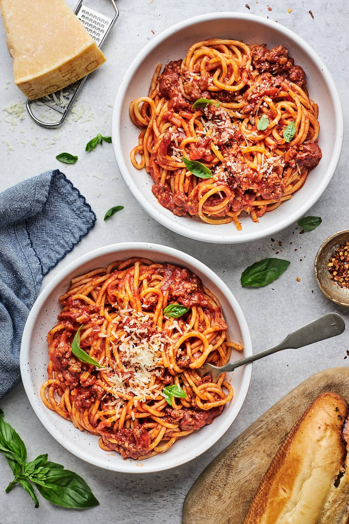 bowls of spaghetti with Parmesan cheese. 