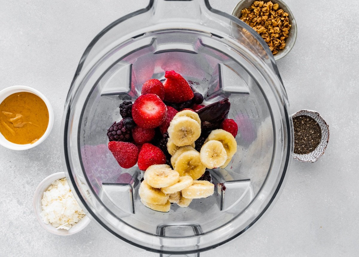 frozen fruit in blender to make acai bowl.