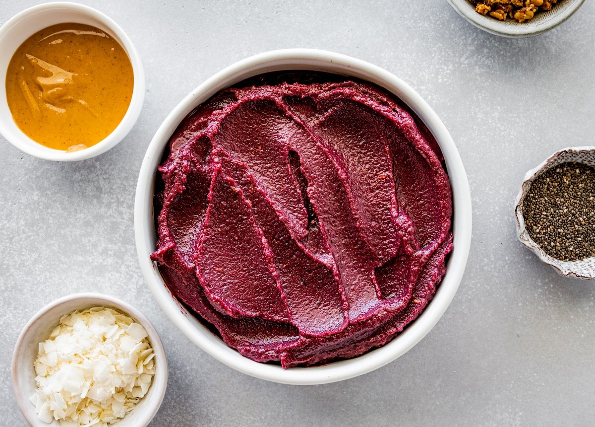 acai bowl with toppings on the side. 