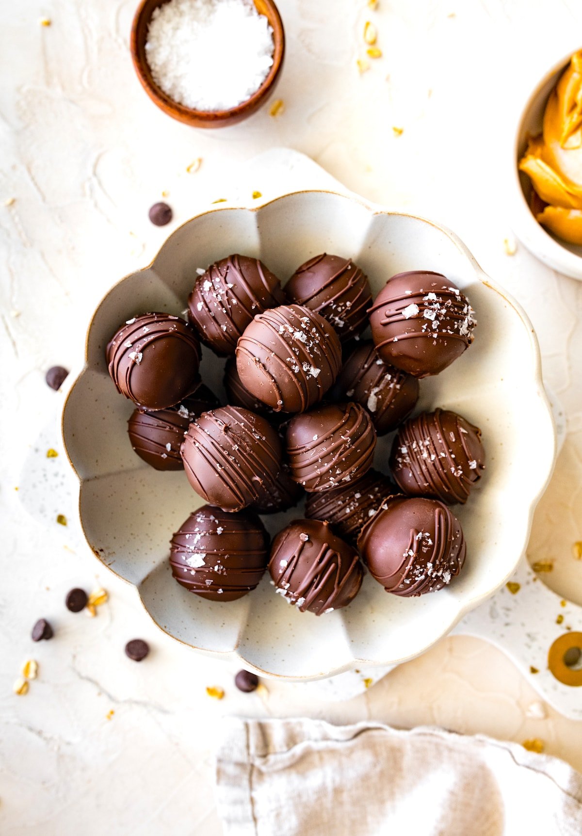 peanut butter protein balls dipped in chocolate on plate. 